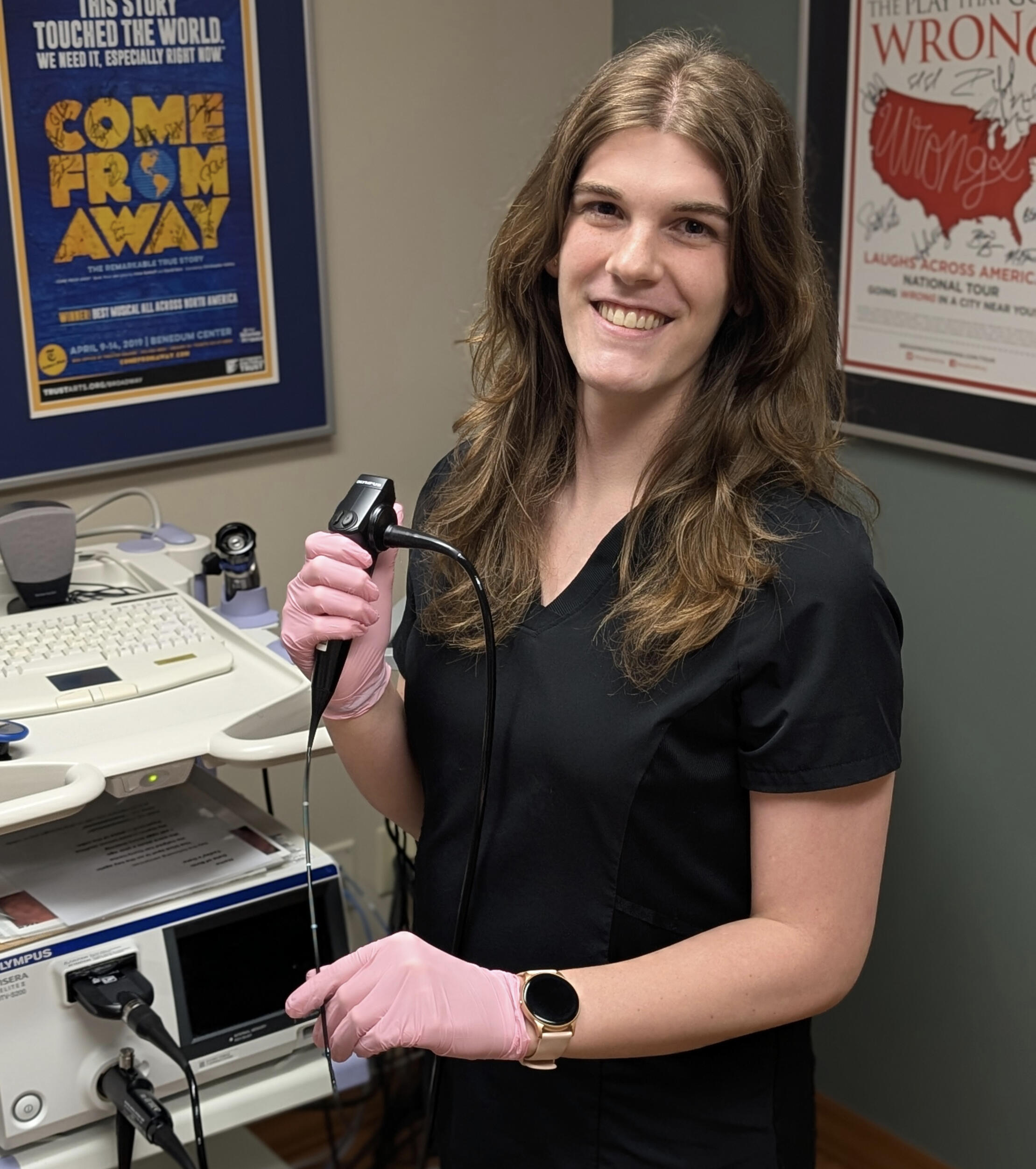 An image of Nora Mahon holding a flexible laryngoscope.